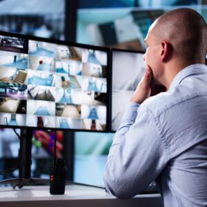Security guard monitoring surveillance screens