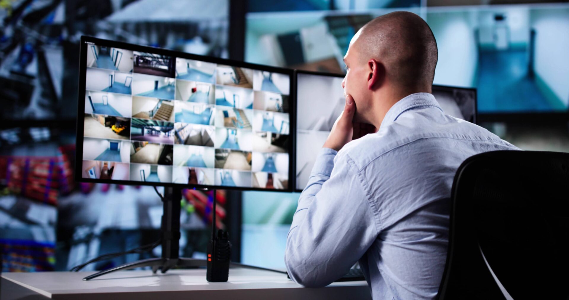 Security guard monitoring surveillance screens