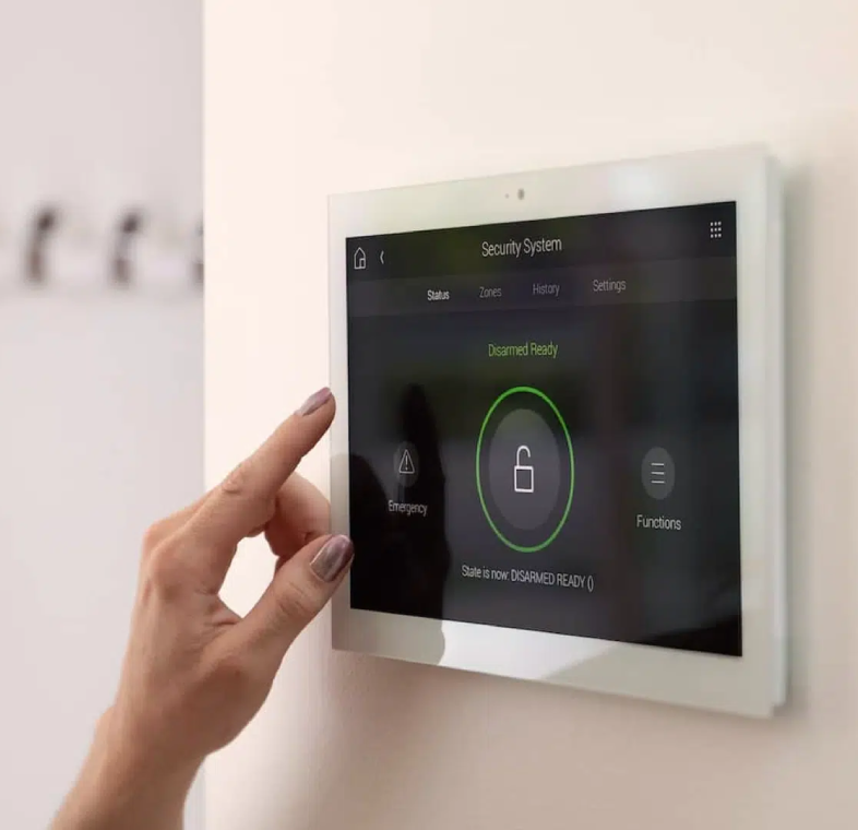 Hand touching home security system touchscreen
