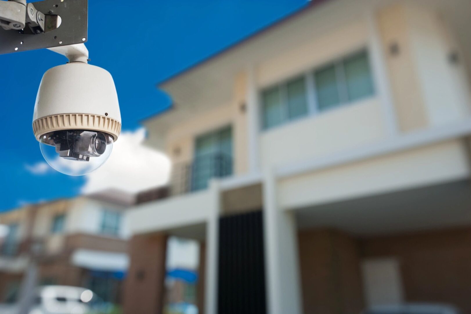 Outdoor dome security camera monitoring residential property