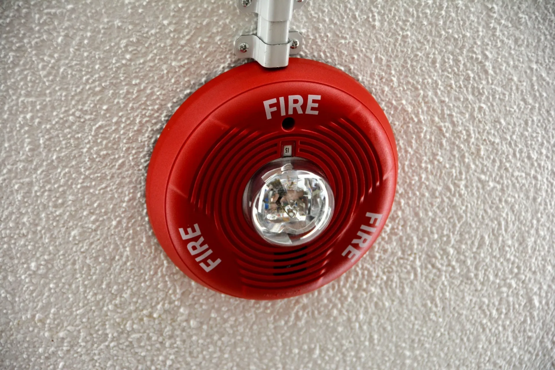 Red fire alarm strobe on ceiling