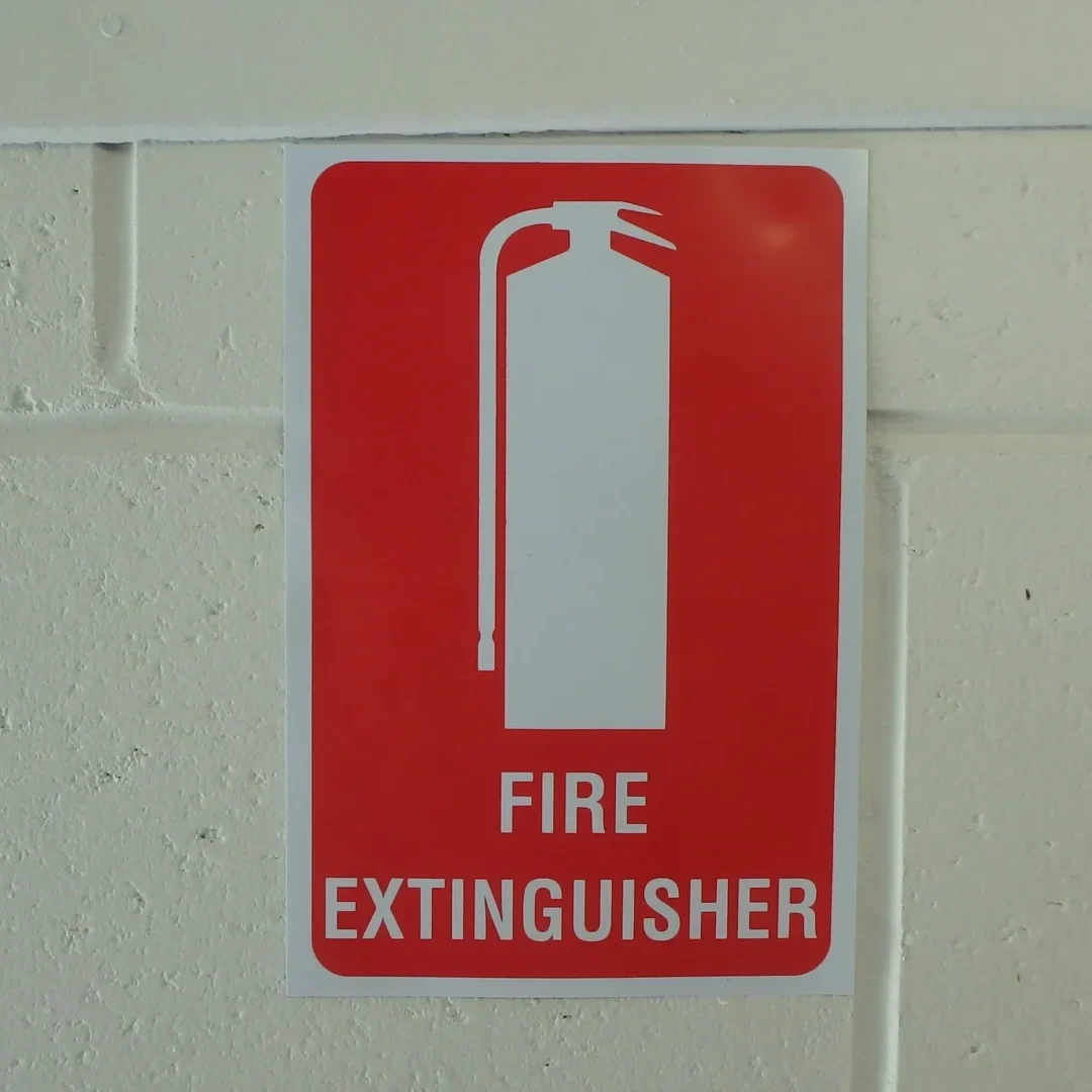Red fire extinguisher sign on wall